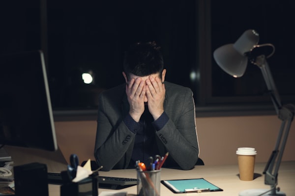 Income capped stressed worker at desk